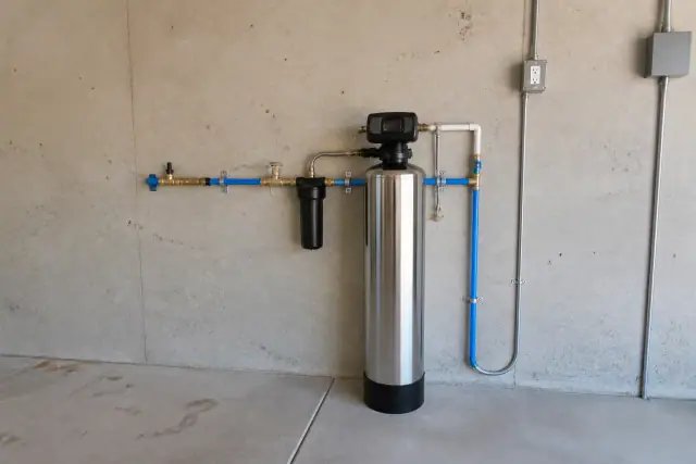 Salt-free water conditioner system installed on a garage wall in Mesa, AZ.