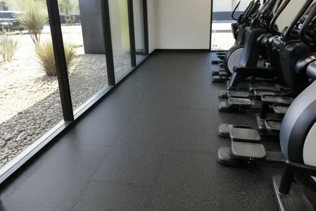 Interlocking rubber floor tiles installed around cardio machines in a Phoenix, AZ office gym.