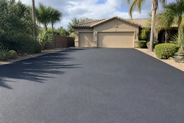 Freshly paved asphalt driveway at a residential home in Scottsdale, AZ.