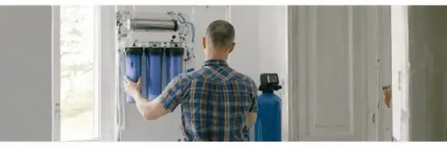 Technician installing a water filtration system