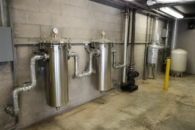 Industrial stainless steel bag sediment filters installed in a commercial mechanical room in Tempe, AZ.