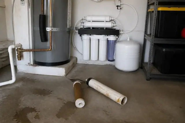 New water purification system installed in a garage in Tempe, AZ, with old filters on the floor.