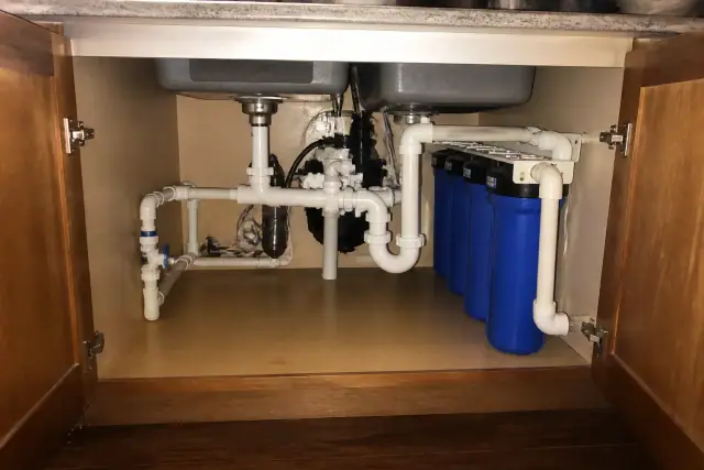 Commercial sediment filtration system installed under a residential kitchen sink in Tempe, AZ.
