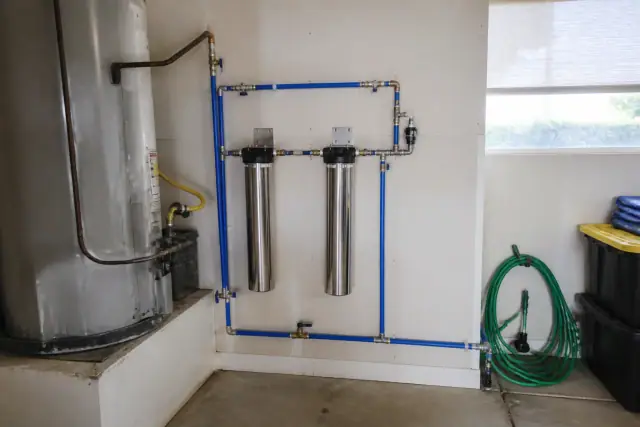 Commercial water filtration system installed in a garage next to a water heater in Scottsdale, AZ.