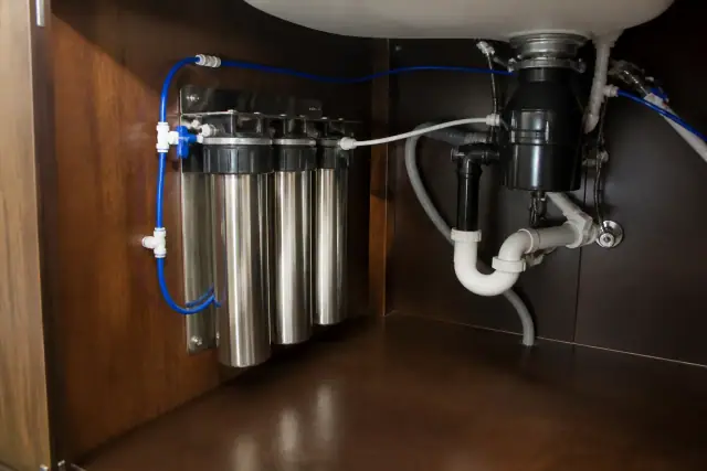 Commercial water filtration system installed under a residential kitchen sink in Tempe, AZ.