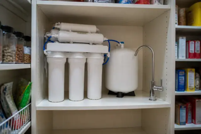Reverse osmosis water filtration system installed on a pantry shelf in a home in Tempe, AZ.