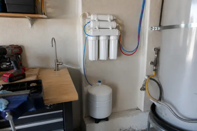Reverse osmosis water filtration system installed on a garage wall in Tempe, AZ.