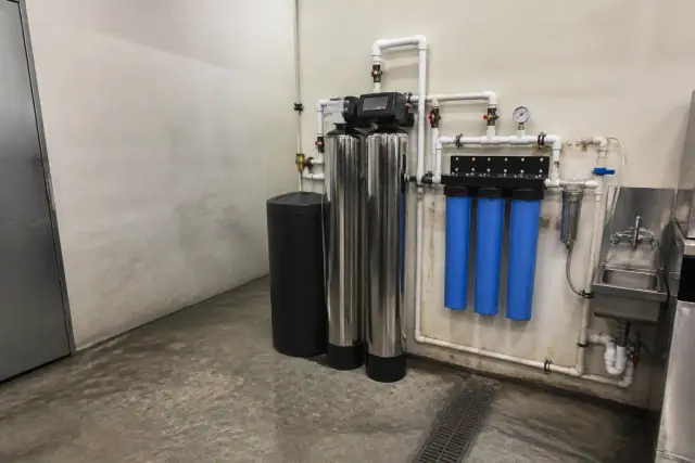 Water softener and filtration system installed in a restaurant utility room in Glendale, AZ.