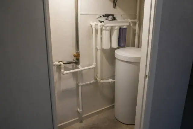 Whole-house water filtration system installed in a mechanical closet in Tempe, AZ.