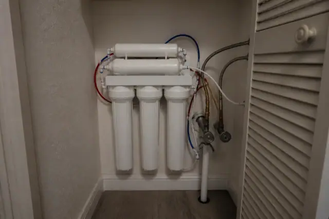 Multi-stage reverse osmosis water filtration system installed in an apartment mechanical closet in Tempe, AZ.