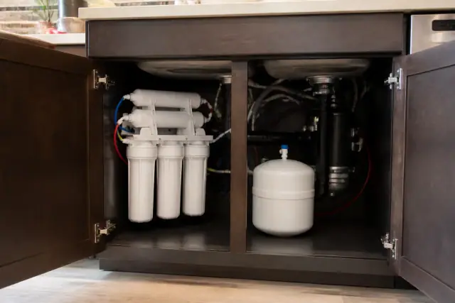 Multi-stage water filtration system installed under a kitchen sink in Tempe, AZ.