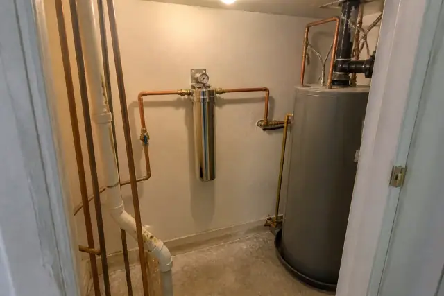 PFAS water filtration system with copper piping installed in a residential mechanical closet in Tempe, AZ.