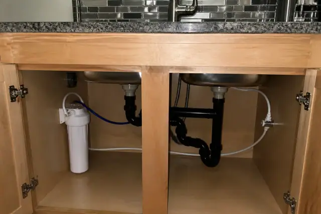 Under-sink water filtration system installed in a kitchen cabinet in Mesa, AZ.