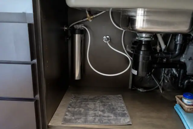 Under-sink water filtration system installed in a kitchen cabinet in Tempe, AZ.