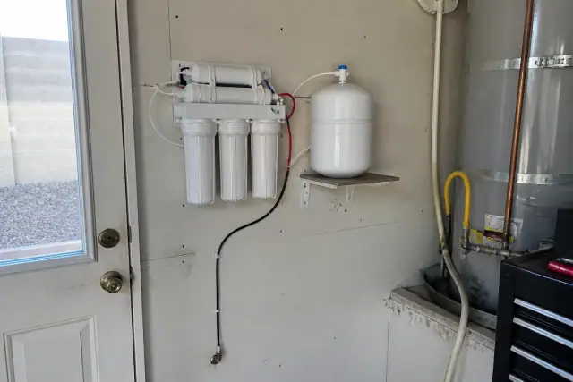 Reverse osmosis water filtration system installed on a residential garage wall in Surprise, AZ.