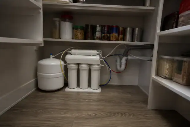 Reverse osmosis water filtration system installed on a shelf in an Avondale, AZ pantry.