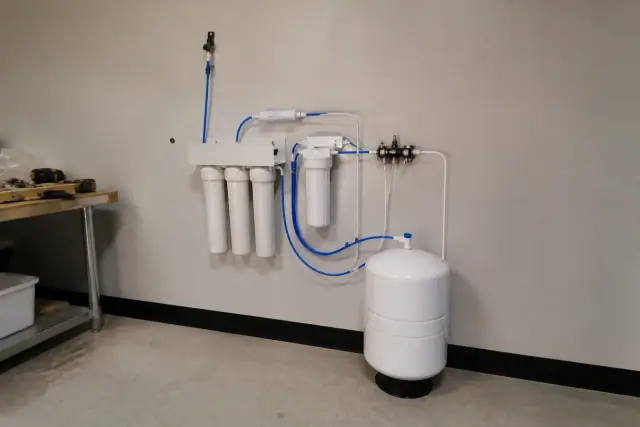 Reverse osmosis water filtration system installed in a utility room in Gilbert, AZ.
