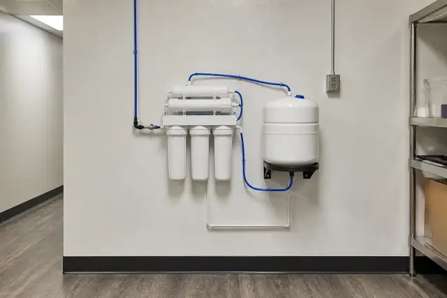 Reverse osmosis filtration system installed on a wall in a service room in Chandler, AZ.