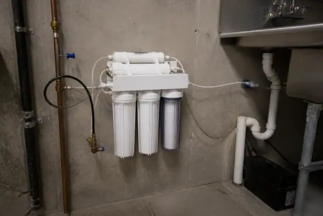 Reverse osmosis water filtration system installed under a sink in a commercial room in Tempe, AZ.