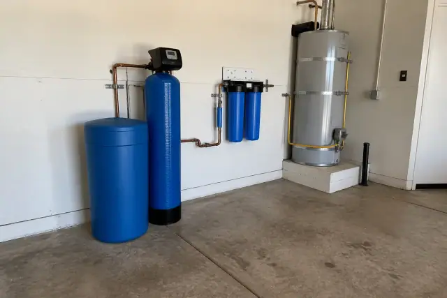 Water softener and under-sink filtration system installed next to a water heater in a Phoenix, AZ garage.