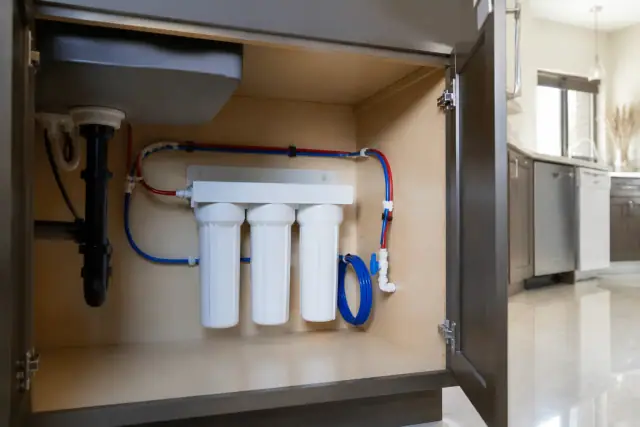 Under-sink water filtration system installed in a modern kitchen cabinet in Scottsdale, AZ.