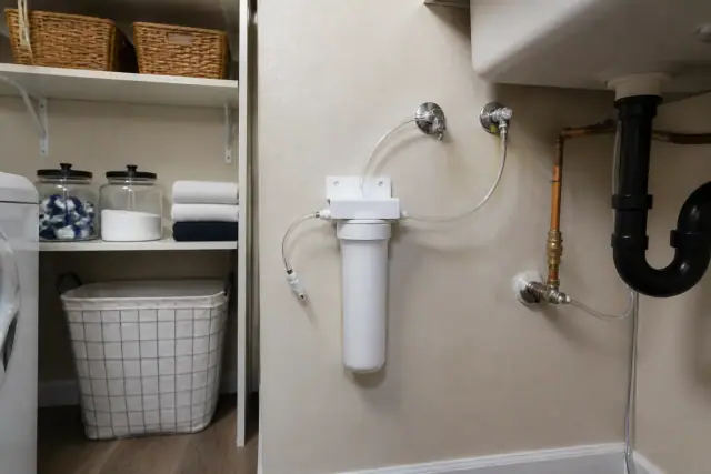 Water filtration system installed under a laundry room sink in Gilbert, AZ.