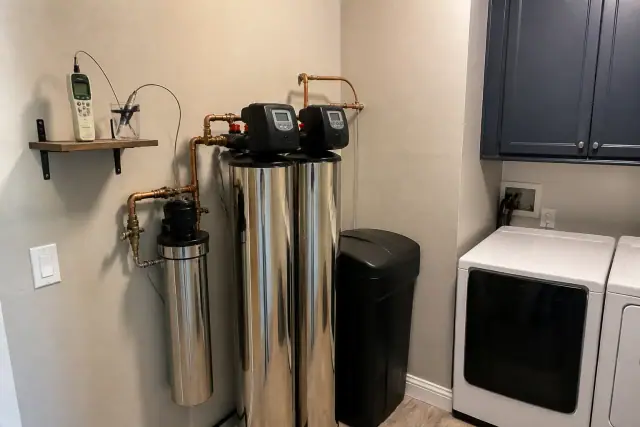 Water softener and filtration system with copper plumbing installed in a Scottsdale, AZ laundry room.