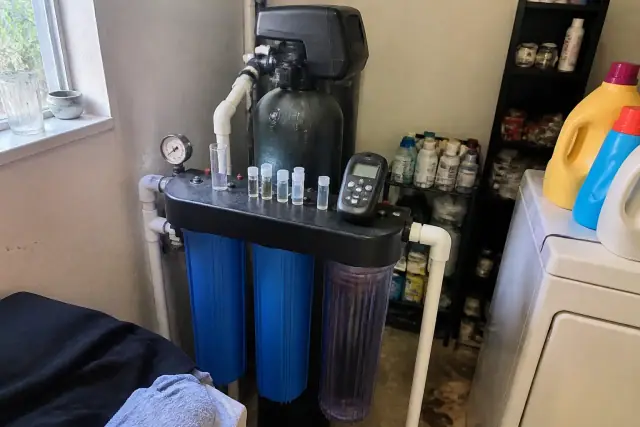 Water testing equipment and sample vials on a filtration system in a laundry room in Tempe, AZ.